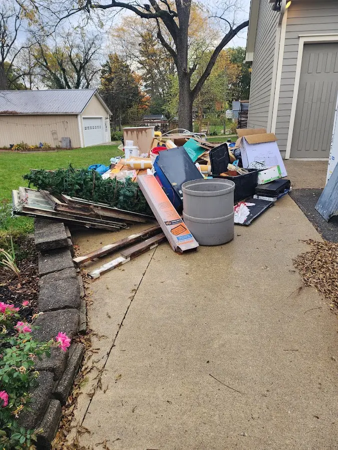 Dumpster being loaded with debris for Roofing Dumpster Rental in Ulysses